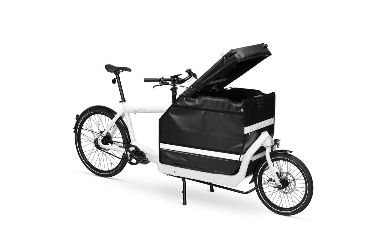 A white eBullitt cargo bike with a lidded black cargo box mounted on the cargo bed. The lid is open.
