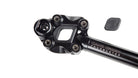 Closeup of a suspension seatpost head on a white background, with the elastomer on the side. Print on the seatpost reads "Cane Creek Thudbuster"