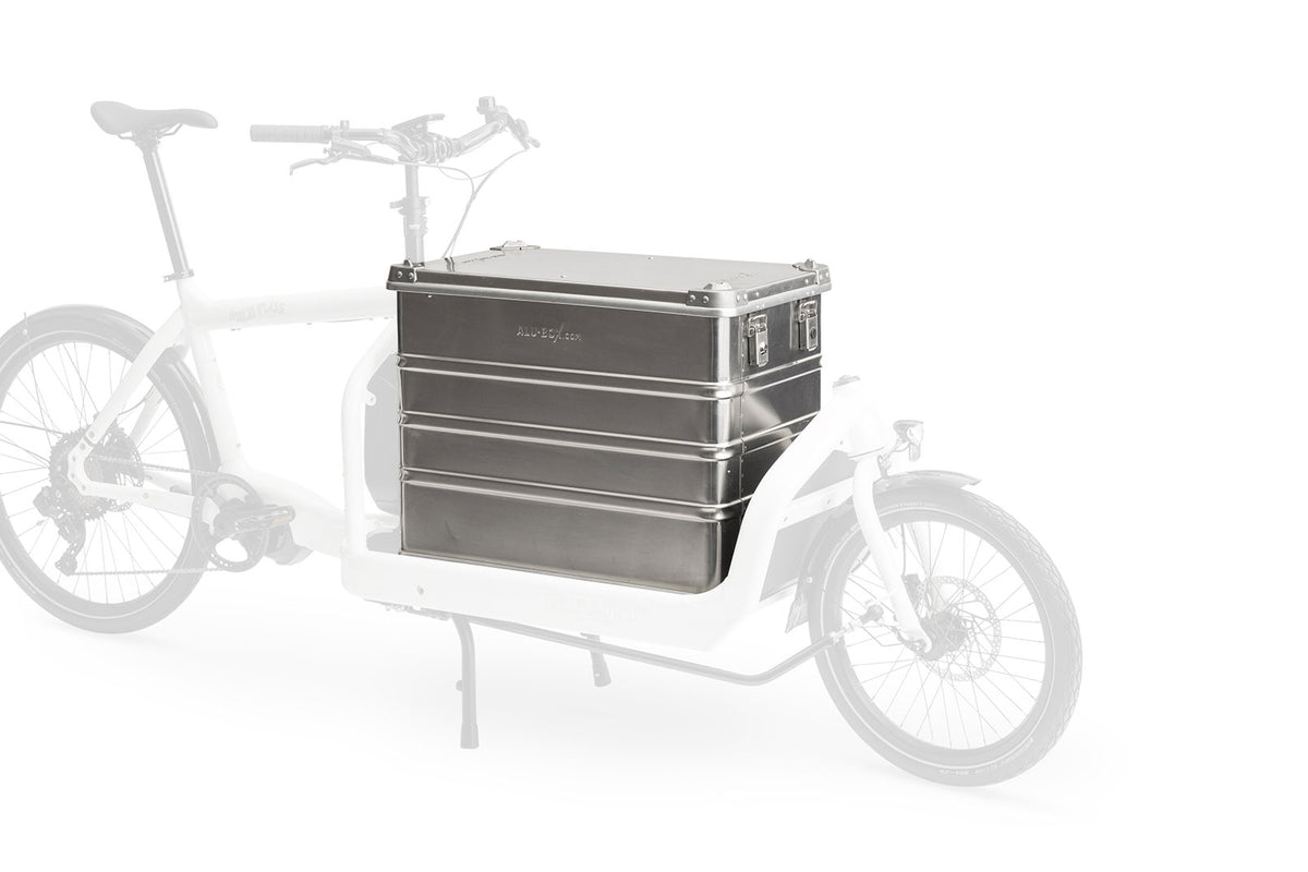 A lidded aluminium transport box mounted on the cargo bed of a Bullitt cargo bike