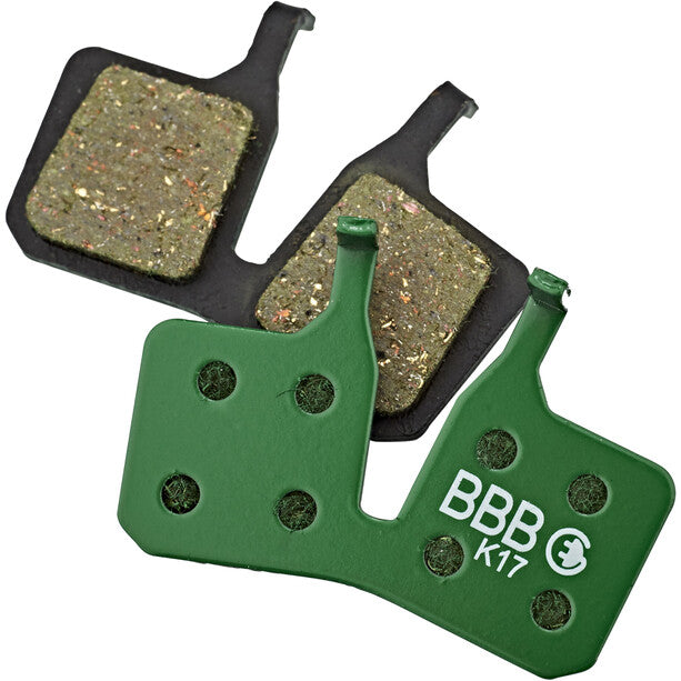 Two brakepads on a white background, one with the backside facing the camera. The backside is green with "BBB" and "K17" printed on it.