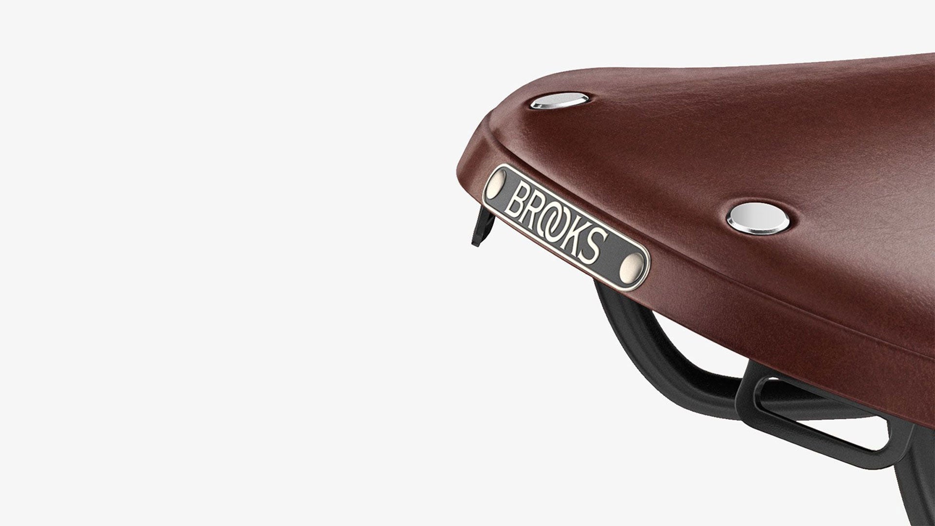 Closeup of Brooks label on B17 brown saddle seen from the back on a white background