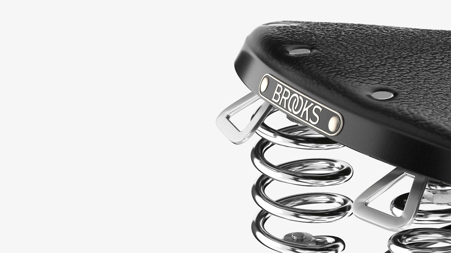 Closeup of Brooks label on B67 black saddle seen from the back on a white background