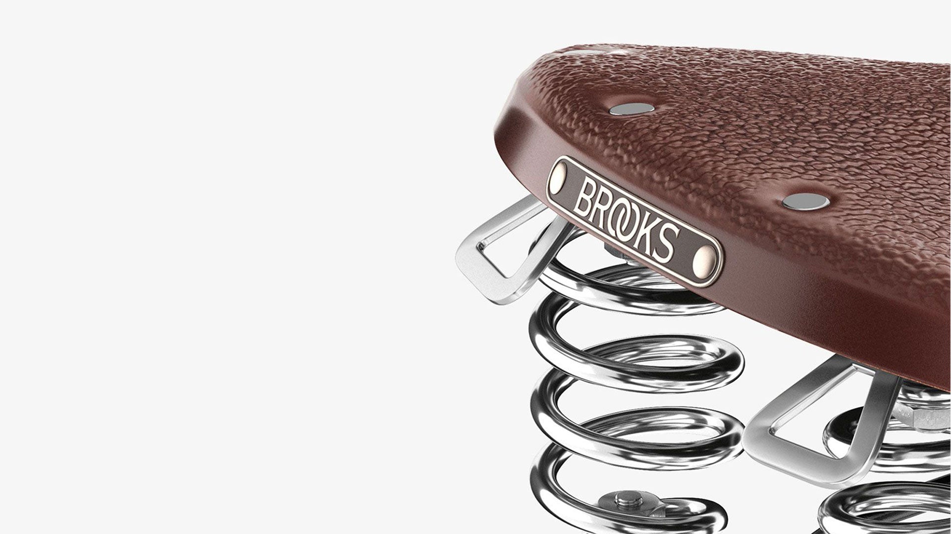 Closeup of Brooks label on B67 brown saddle seen from the back on a white background