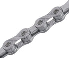 Close-up of bike chain links with "KMC" engraved on each link