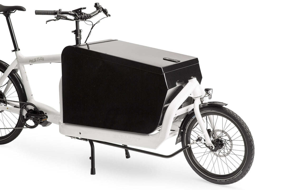 A white eBullitt cargo bike with a lidded black aluminium cargo box mounted on the cargo bed
