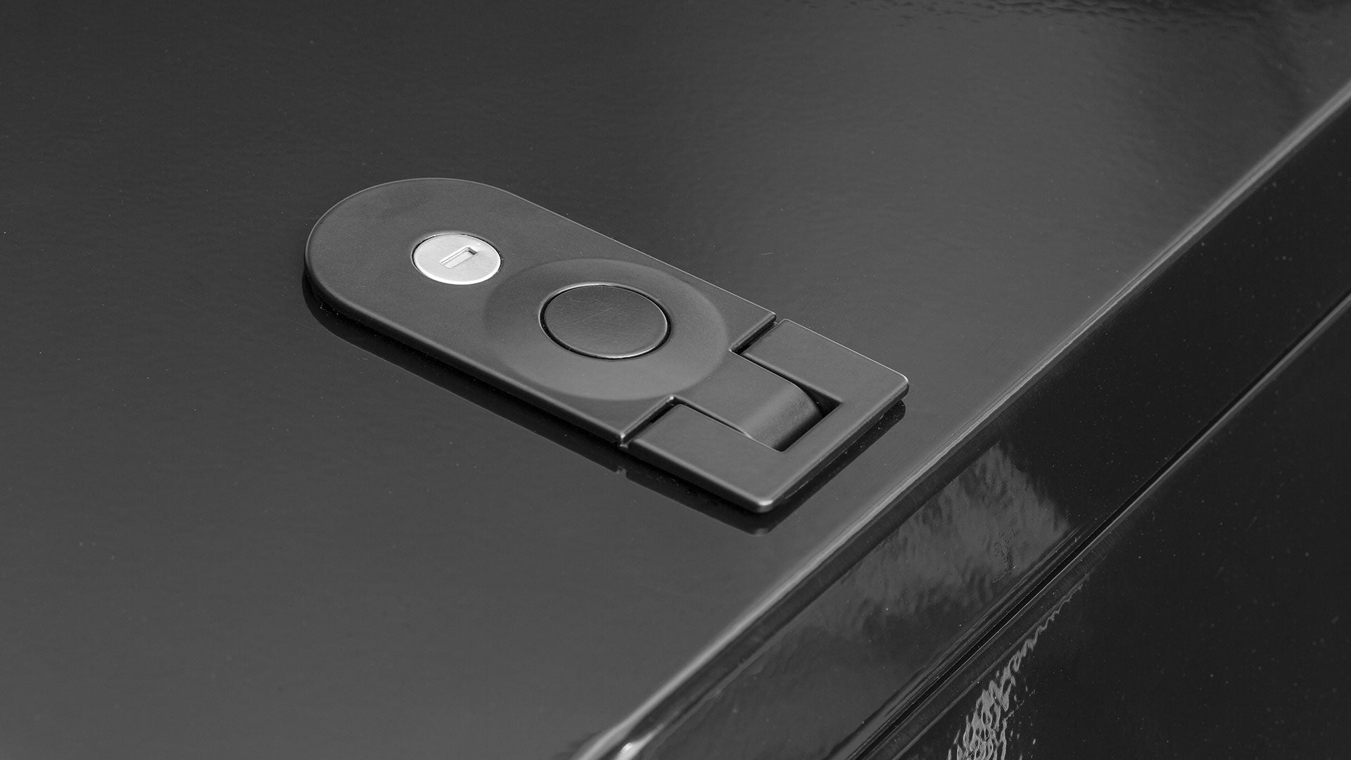 Closeup of the lock in the lid of a black convoy cargo box