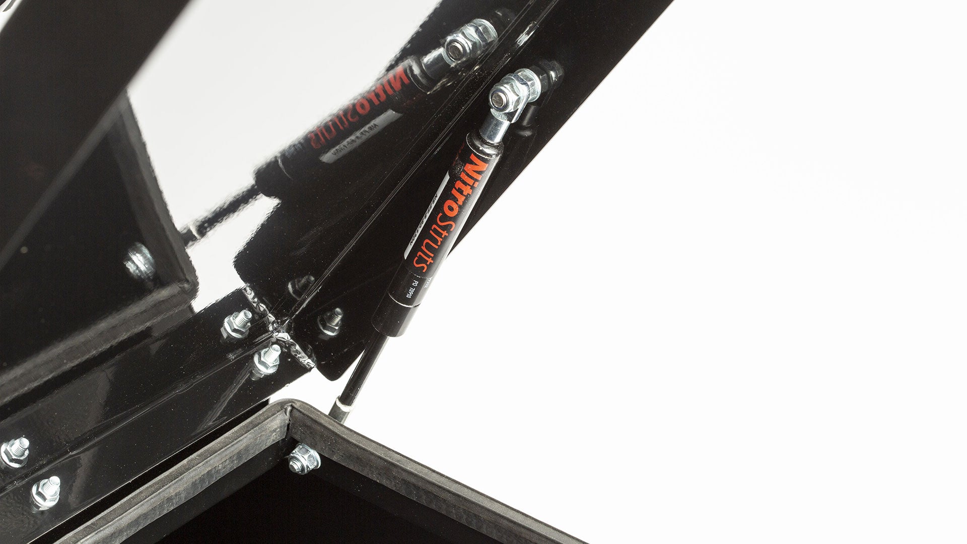 Closeup of the hydraulic arm holding the open lid on the convoy cargo box