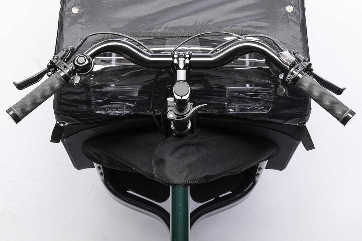 Closeup of the handlebar on a dark green Bullitt cargo bike, seen from above.