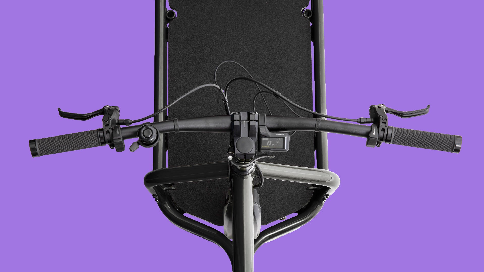 Closeup of the handlebars of an electric Bullitt cargo bike seen from above showing the controls and display.