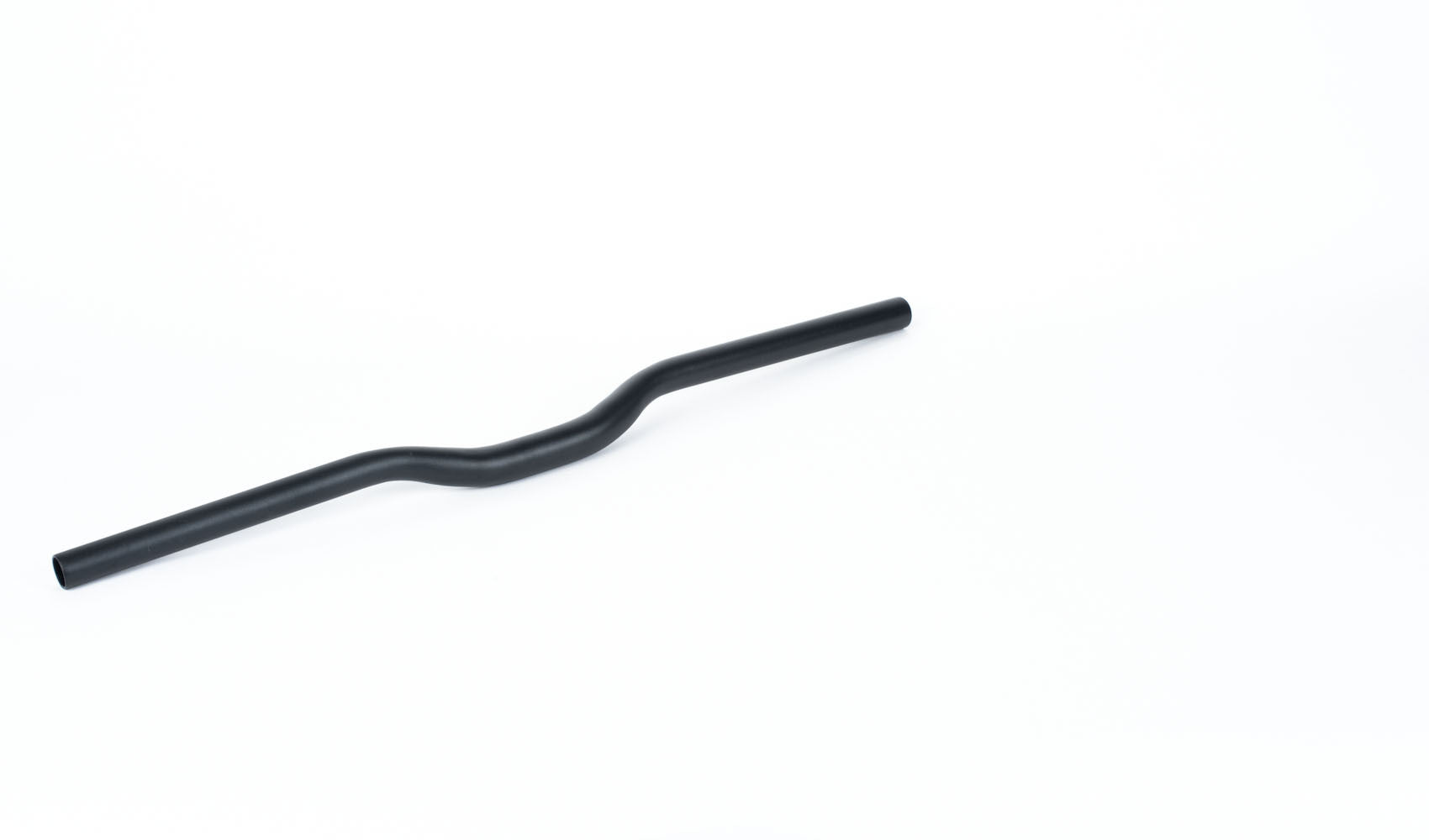 A handlebar with a slight rise lying on a white surface
