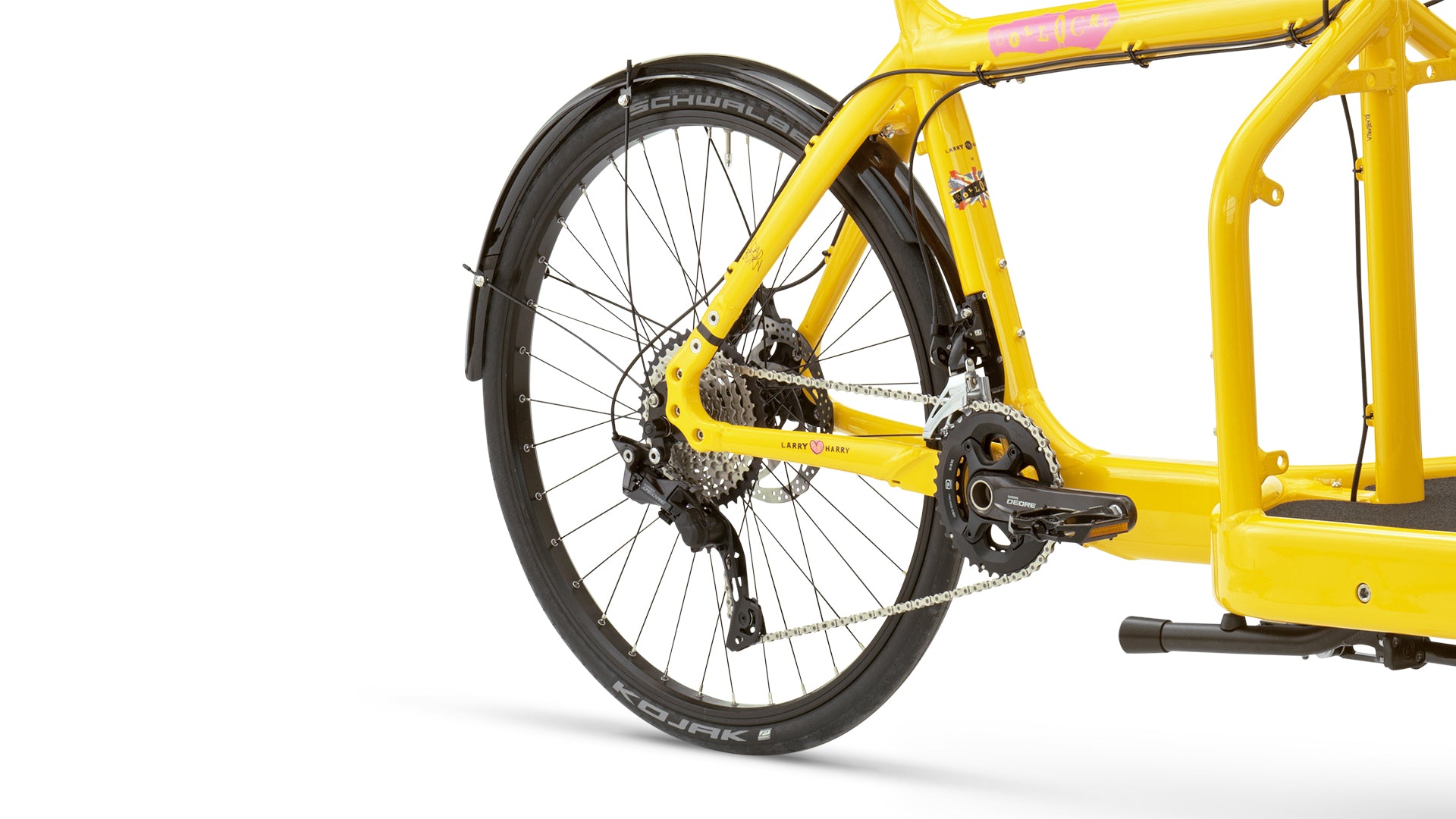 Closeup of a yellow Bullitt cargo bike, rear wheel mounted with a Schwalbe Kojak tyre.