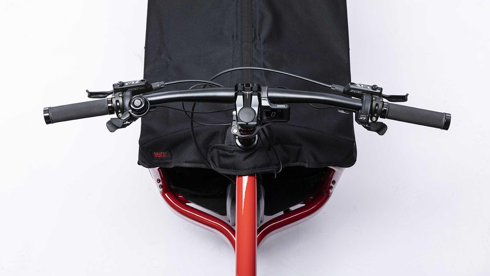 Closeup of the handlebar on a red eBullitt, seen from above.