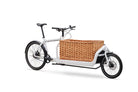 White Bullitt cargo bike with a wicker basket on a white background