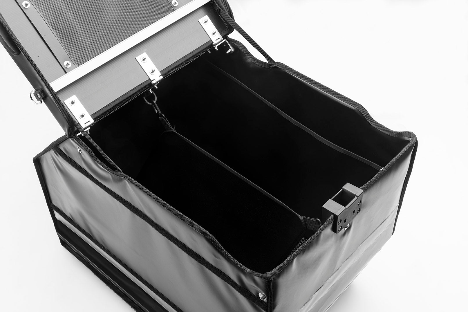Black BagPRO box for Bullitt cargo bikes, with the lid open. Inside you can see two removable soft dividers, as well as a netting pocket on the inside of the lid.