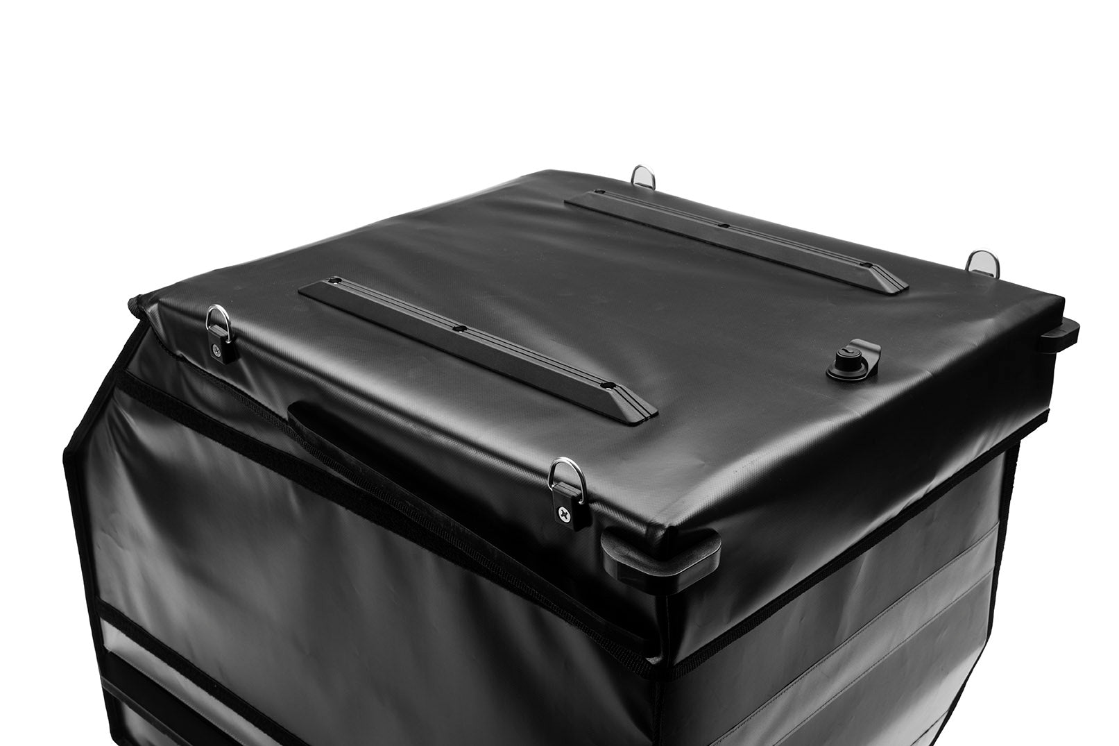 Black BagPRO box for Bullitt cargo bikes, with the lid closed. On the top of the lid you can see anchoring points for attaching extra cargo and plastic bumpers to protect the lid and the integrated lock.