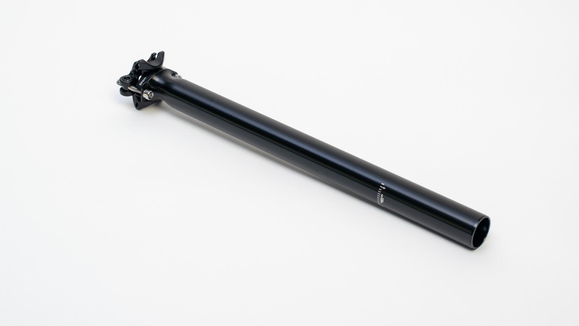 A long black seatpost on a white surface