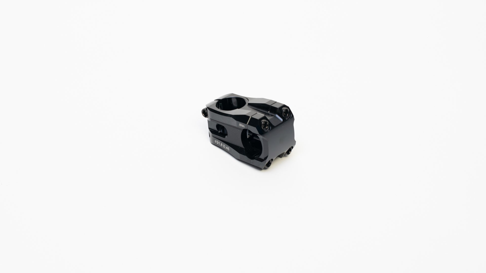 A short black stem on a white surface