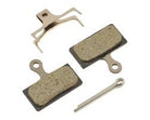 Alfine disc brake brakepad set. Two brakepads, a splitpin and retaining clip on a white surface.