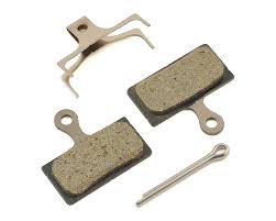Alfine disc brake brakepad set. Two brakepads, a splitpin and retaining clip on a white surface.
