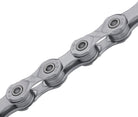Close-up of bike chain links with "KMC" and "X10" engraved on each link
