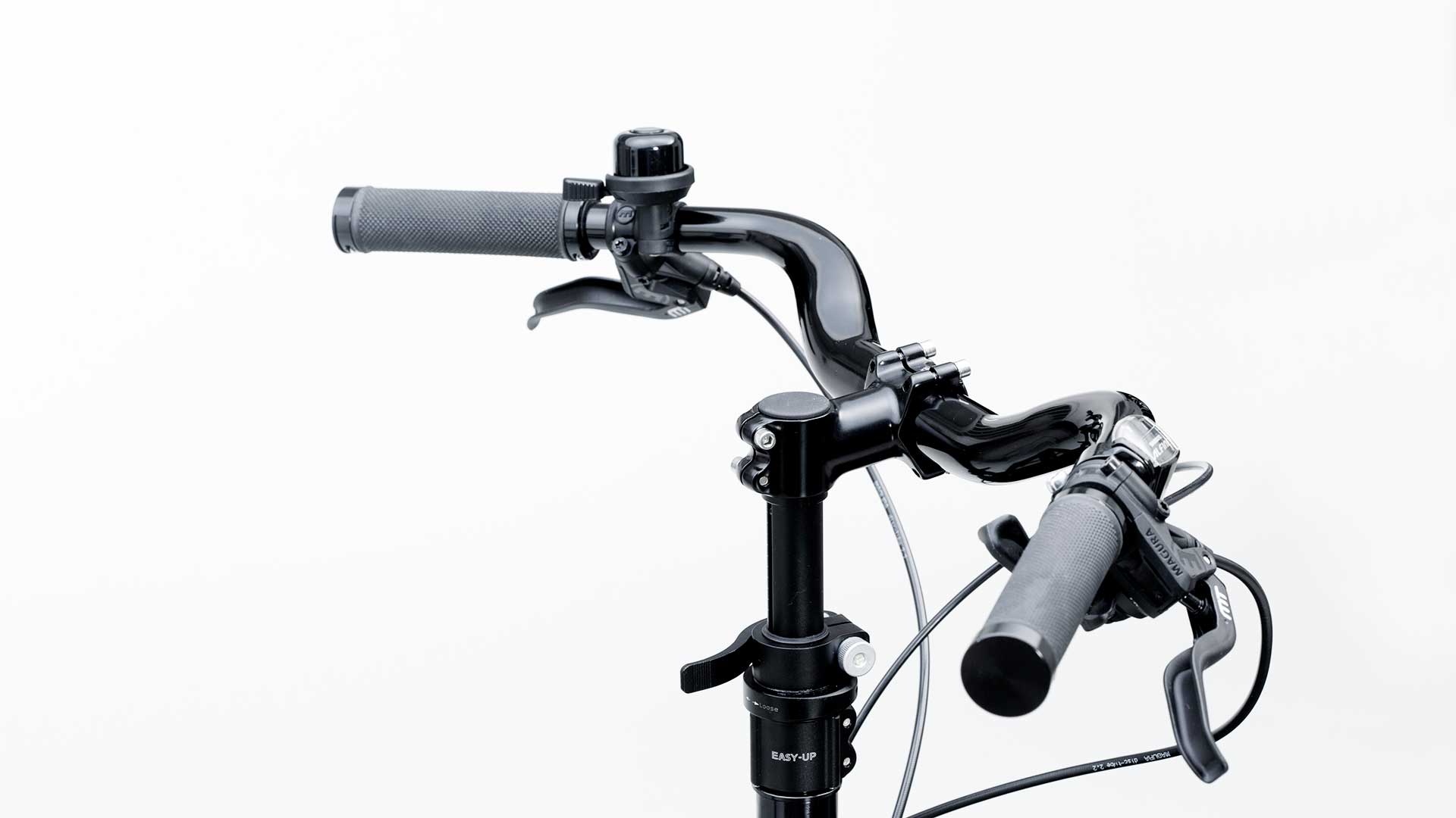 A black cruiser style handlebar mounted on a Bullitt cargo bike, seen from an angle