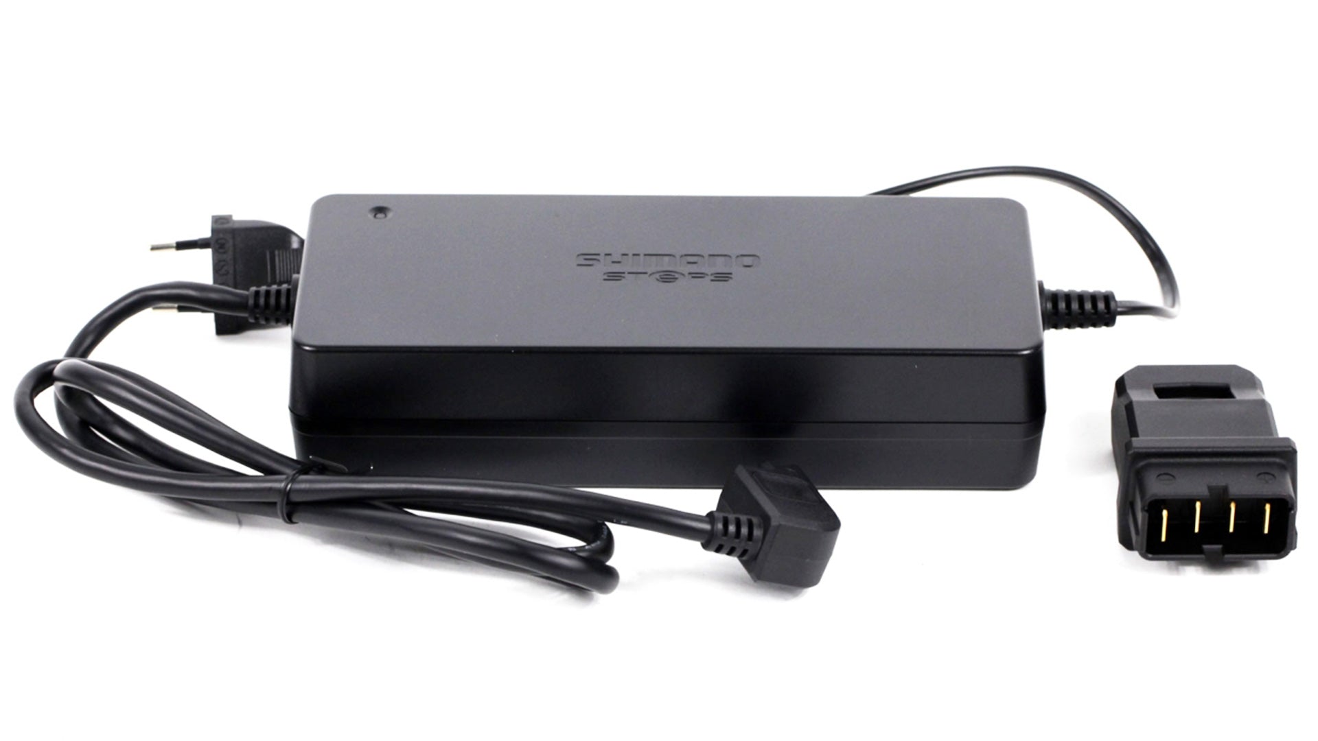 Shimano e-bike battery charger on white background. The charger has a C-type plug and an adapter with 4 pins.