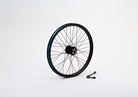 A 20" bike wheel without tyre, standing on a white surface. Beside it is an axle with quick release.